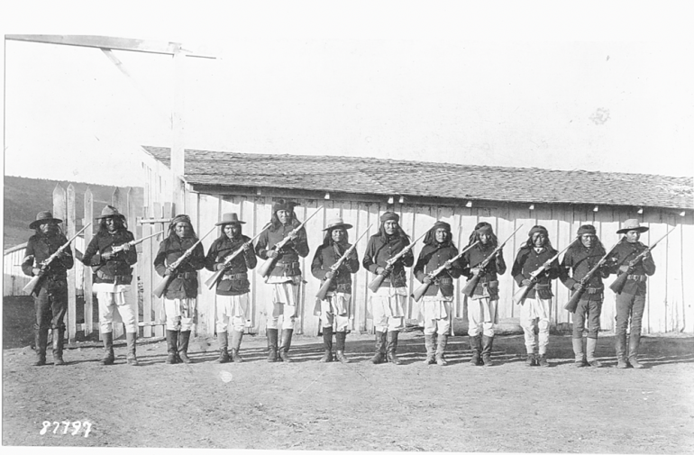 Period photo showing a mix of native dress and army issued clothing.  