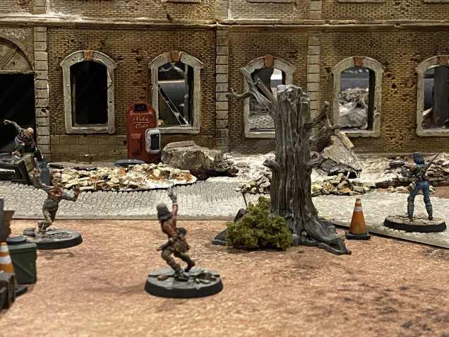 Piper advances towards the main entrance and cart.  In doing so she inadvertently walks into the path of the Machine Gun Turret.  The whirling mechanics and clatter or machinegun rounds in turn disturbs the Feral Ghouls who are initially attracted by the sound and then, on seeing Piper, may a headlong charge towards her.  The ghoul Charge also sets the Turret off and rounds pepper the floor behind the Ghoul as it rushes forward.  In the meantime, Preston uses long range fire to clear out some Radroaches.  