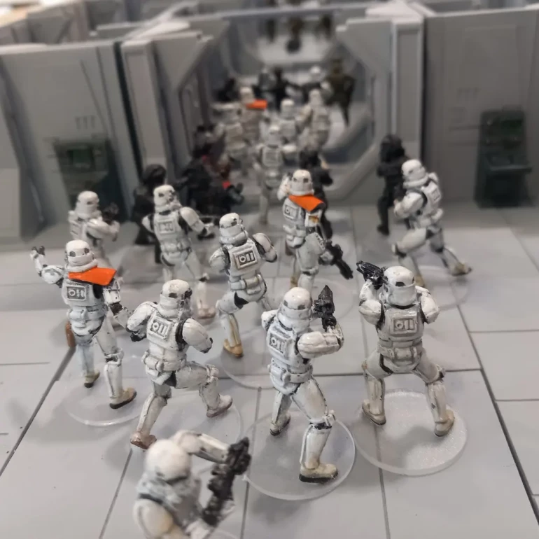 Stormtroopers pile down the corridor towards the small band of heroes