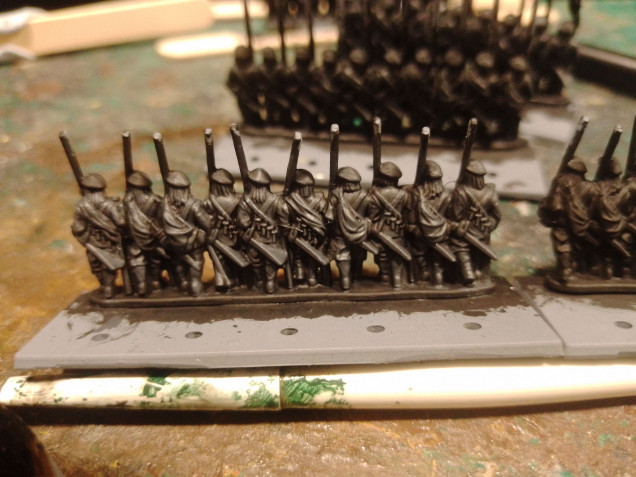 Paint them black then drybrush with grey. Then paint the unit as normal.