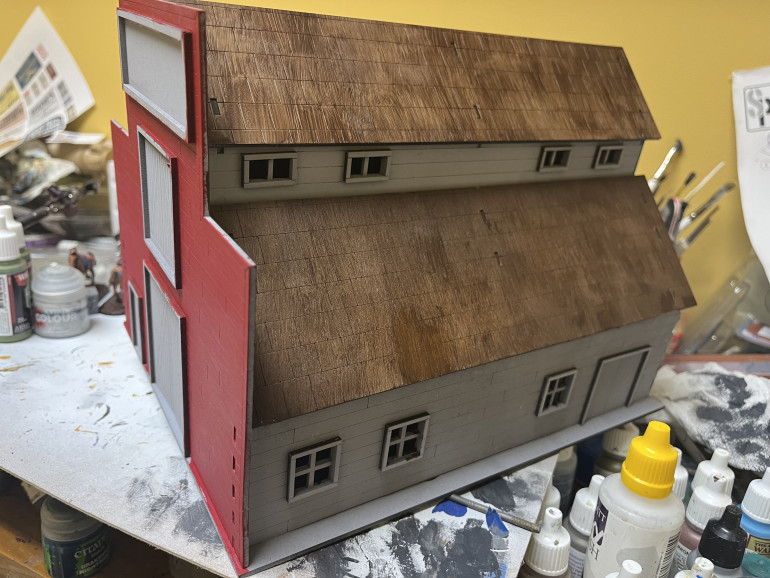 Painted the roof tiles using burnt umber acrylics.  Now it’s decision time on what colors to use on the rest of the stable.  