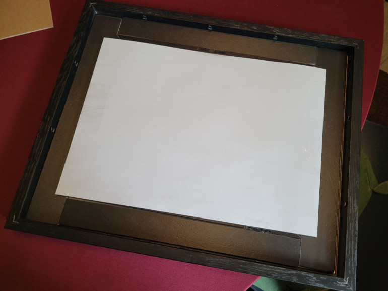 Shifting the piece of paper around so it sits in the frame properly is harder than it looks.
