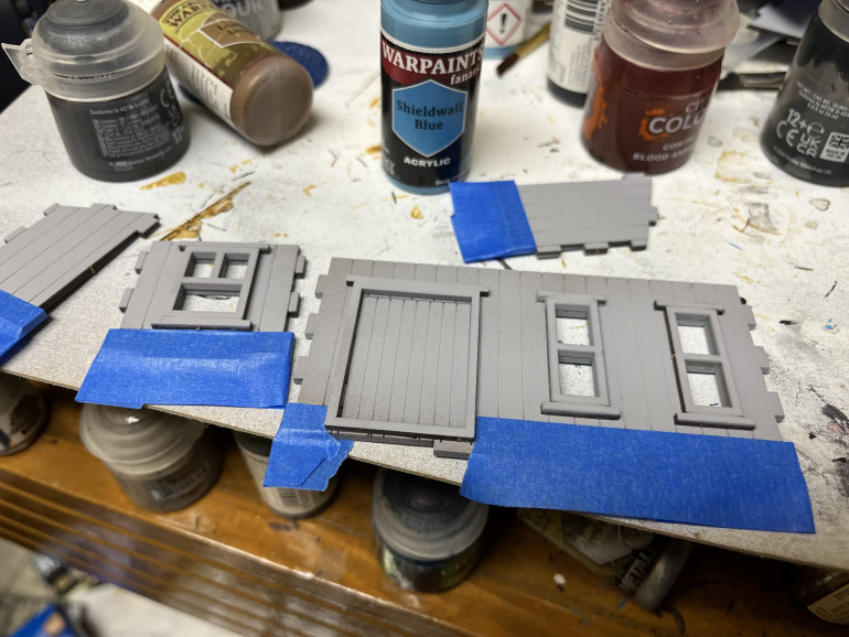 I painted and partially assembled a small wood and stone shack.  I marked off the stone areas and will paint up the unmasked areas as wood.  