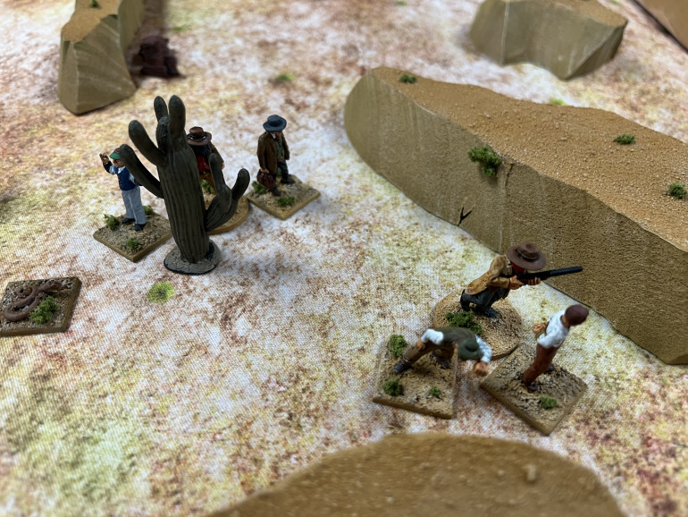 Bull Ballard and Jedediah Johnson hurry through the arroyo cautiously and wisely avoiding the snakes after seeing what happened to one of the Tin Men