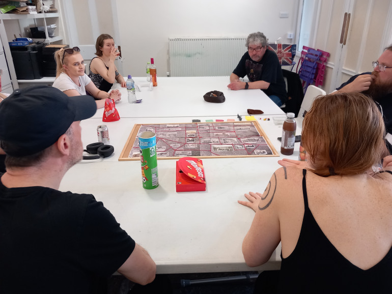 All round the table for the big game. We had four teams playing four constables on a mission to solve as many crimes as possible while I ran around the table handing out cards and explaining the rules.