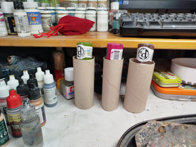 My P3 paint pots have a bad habit of having their lids crack and the paint drying up.  I am slowly transferring them over to dropper bottles.  Turns out toilet roll tubes are great for supporting slow draining paint pots in small funnels.  Here's the set I bought.  I went with 30ml bottles.  The 20 pack includes 4 funnels.  https://www.amazon.co.uk/dp/B01N8PCUI0/