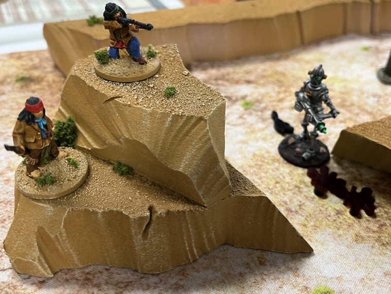 Great Eagle and Sees Far take up positions on the high ground as the sole surviving Tin Man staggers away attempting to replace the power pack on his Raygun.  