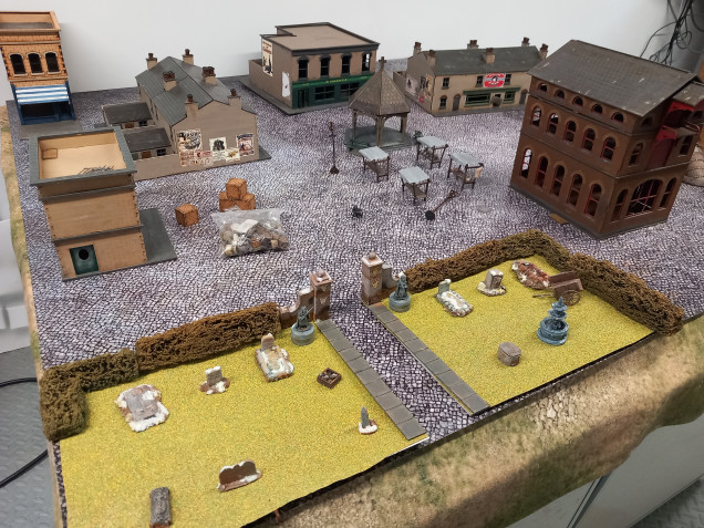 Before I started 3D printing I got out my current collection to see what I could put together. There are a number of different environments to play games on. One is residential so I made a little grave yard to add a bit of green to the cobbled mat.