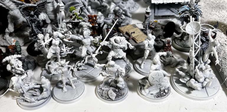 Small base characters that are primed and waiting for paint.