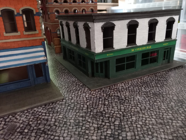 The pub from timeline miniatures was originally used in my 1916 Easter Rising game. I've painted the facade white so it stands out more.