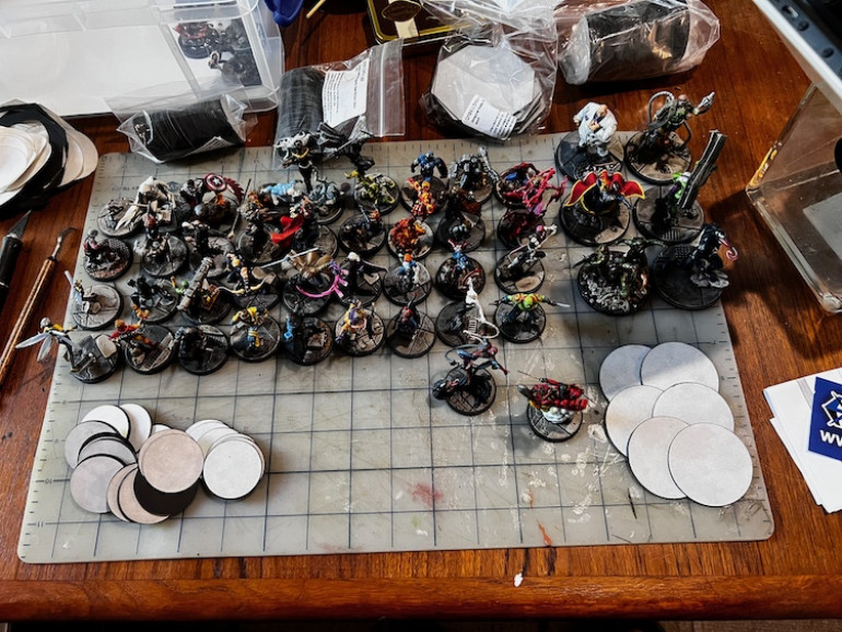 Organized finished minis by base sizes and started peeling the backing from the magnets and sticking them to the bases.