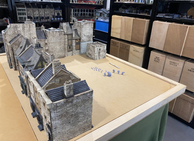 Some of my buildings laid out on my gaming table.  Sure, its playable and serves its purpose, but look at how flat and sterile it is.   It needs texture and contours or levels to really make it feel like the buildings and ground are supposed to be together