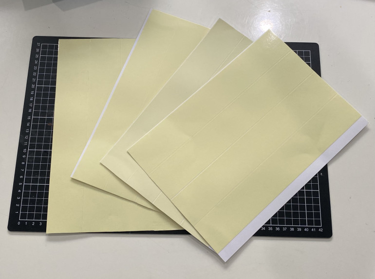 Double sided tape stuck to sheets of card.