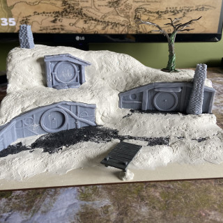 Added some cheap air drying clay to form the shape of the land