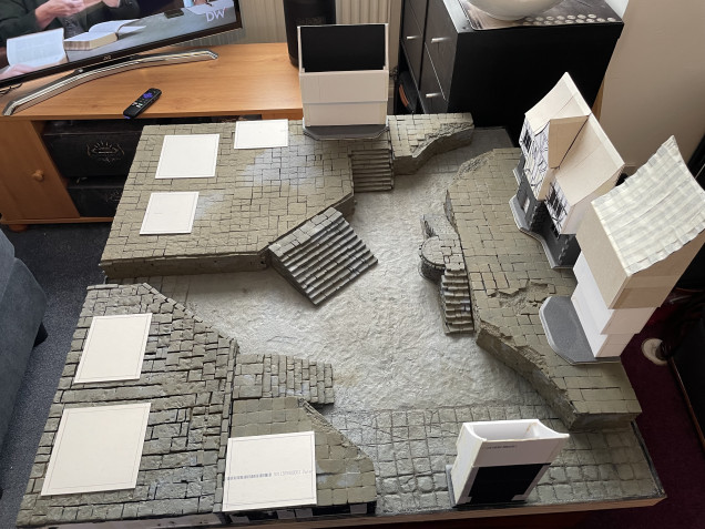 While I had the board laid out I had a think about what I wanted to do now. I place several pieces of card that I’d cut out, roughly 4 inches by 5 inches. These represent the footprint of the buildings whether ruined and accessible or complete sturdy and line of sight blocking.  