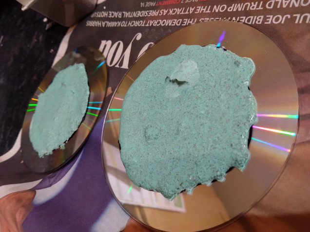 I made a mix of PVA, plaster, green paint and green flock and laid it down as a puddle in the middle of my CD bases.