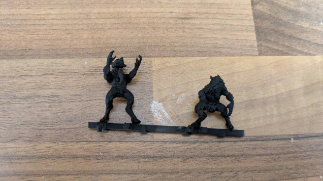 Two primed werewolves. One with an axe in his chest.