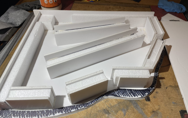 I learnt from previous raised platforms I’ve created for the table that they need support so the flat top doesn’t sag. These supports are pieces of polystyrene packaging sandwiched between two strips of foam card 