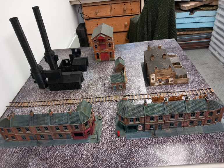 Started on the industrial zone to fight over. The buildings are again fro Hartolia prints and the chimney adds do.w height to the board. I feel like I need an assassin on the top ready to jump. I want to add a lot more walls 