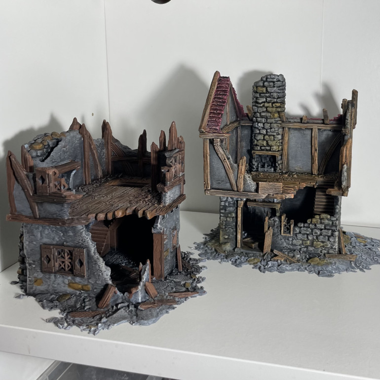 Two of the buildings painted but using different paints to see how they turned out 