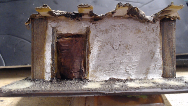 A Close up of the Walls and Cloth. The Cloth was all painted with Snakebite Leather Contrast straight onto the paper Mache. The Curtains are made by sticking a toothpick into the gap and pushing the paper in with an old brush.