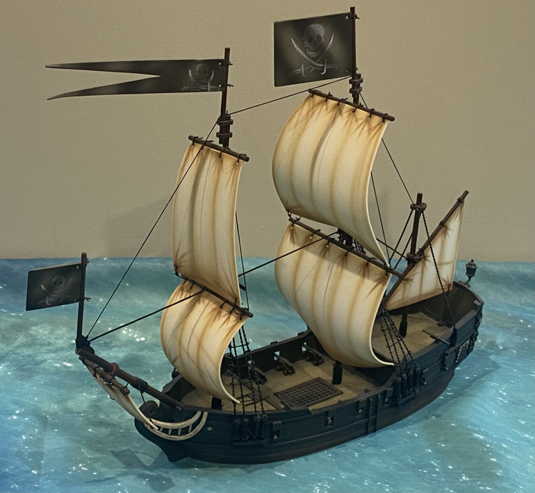 Light Frigate, the first and smallest of the Warships.   Model from Firelock Games.   Shown flying Pirate colours at this time.  Armed with 12 cannons and 4 swivel guns.