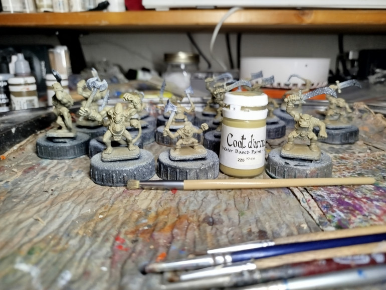 Back to the Green Skins.  Normally I'd carefully build up layers with this recipe, but there's too many of them and they're too repetitive.  Time to drybrush everything and hope for the best.  First drybrush highlight is with Coat d'Arms Khaki