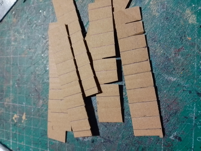 Strips of scrap card were then cut up to make roof tiles