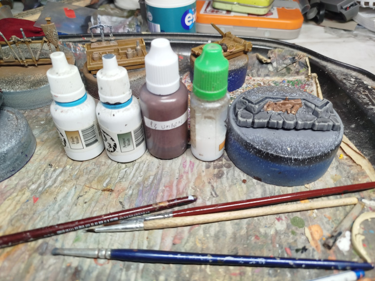 Wash with a mix of the above.  I think its 3:1:1 Flesh: Armour:Umbral, with added water and medium