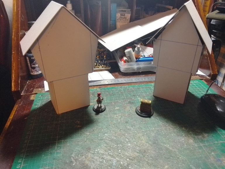 These are the basic shapes I came up with the roofs are separate and the upper buildings walls fold in so the building can be squished flat