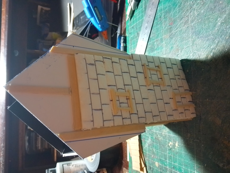 Using a hot glue gun the wall was stuck on then cut coffee sticks up and glued them on as well 