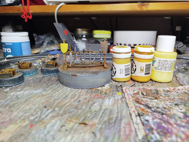 Undercoat the shield with Mouldy Ochre (It's got better coverage than other yellows), then base coat with Cygnus Yellow.  Finally highlight with Lemon yellow