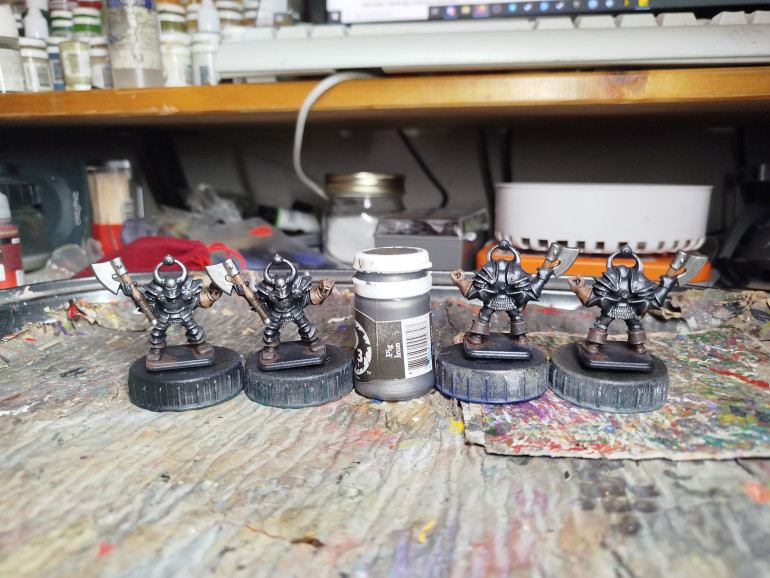 The axe was base coated to make it look different to the metal of the armour.  Also, by making it look brighter, it tricks your eye in to seeing the armour as darker