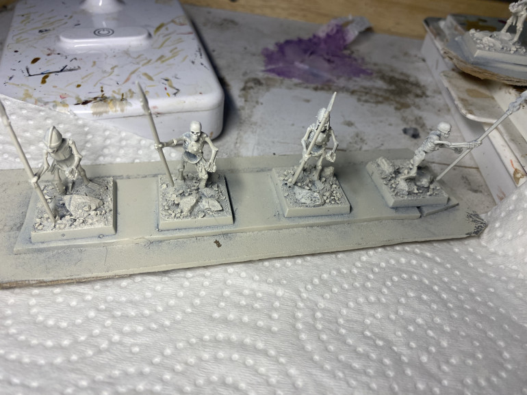 Prime with Wraithbone, than a very light drybrush of pure white ink. 