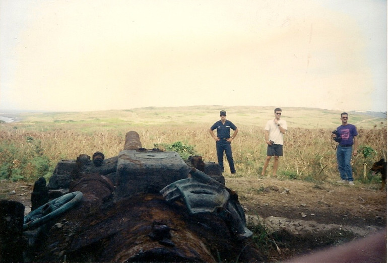 This and the next photo are of the same gun. The sandbar in the previous photo will be off to the left of this photo.  The coastguardsman in the center was our tour guide. Behind him beyond the low hill in the center of the island is the airfield.  