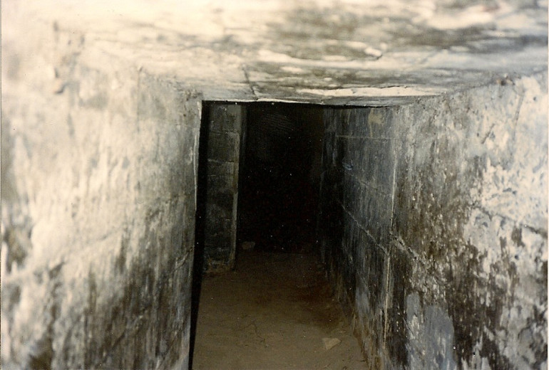 Concrete tunnel built by the Japanese defenders.  I’m 6 feet 1 inch tall (1.85 meters) and was doubled over at the waist while inside taking this photo.  My head and back were touching the roof. As Iwo Jima is still an active volcano, the temperature in here was 120°F (48° C).  Imagine being a Japanese soldier and living in these tunnels for weeks at a time. 