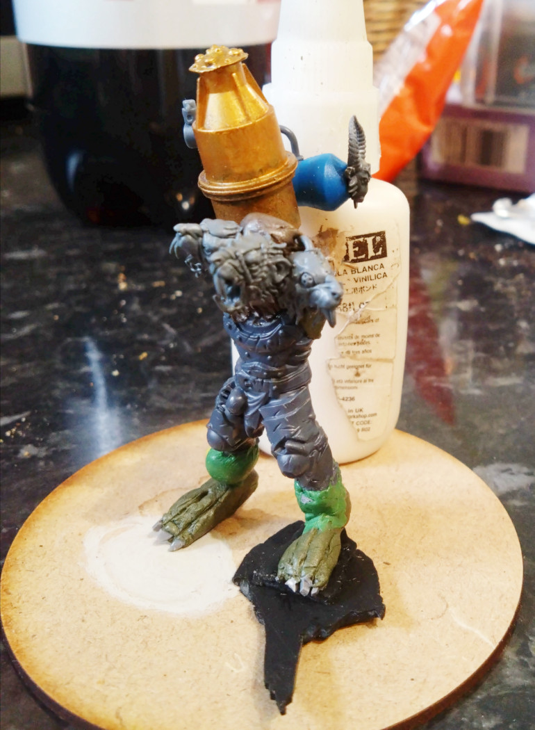 I picked up a 90mm base cheaply at Salute 52. The ogre sized body was smaller than I imagined, so I cut off the feet, made them look more abdominal, added some height with some additional calfage and this gave me an armature to build on.