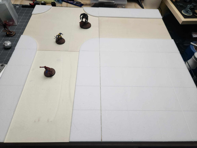 For the tiles, I chose to go with some basic layouts. T-junction, straight-away and no-street. Here's a sample layout with four tiles. Next is going to be priming and painting.