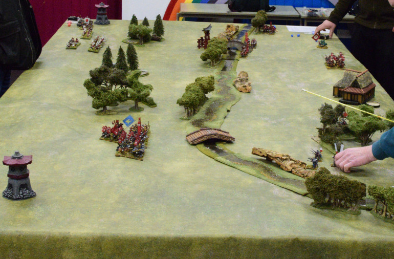 The Defender’s right flank has moved up as a group to try and protect the bridge as the Attackers start to move towards the river. The Defender’s left failed to move as the Attackers reach the river in front of them.