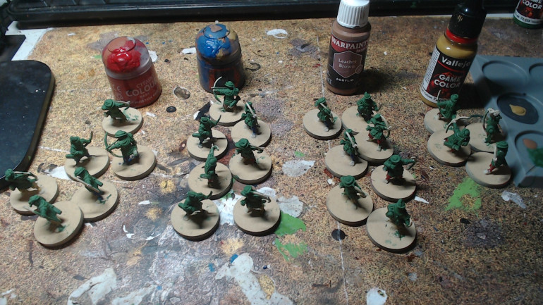 I like to lay it all in in a planned way when I paint. Here I am doing the shirts