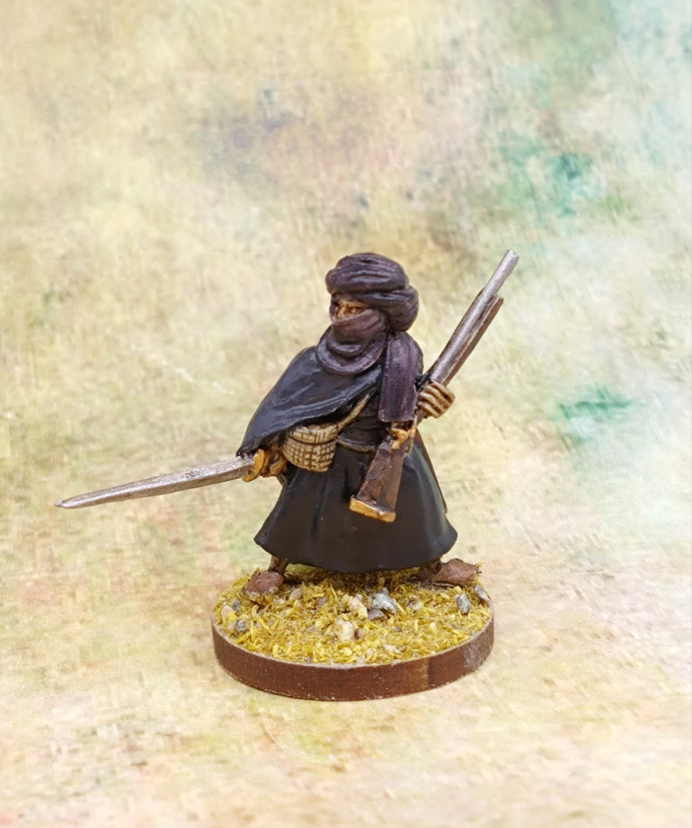 I used Shyish Purple for the turban. A mix of Macragge Blue and Black Legion Contrast for the cloak and just Black Legion for the robes underneath. 