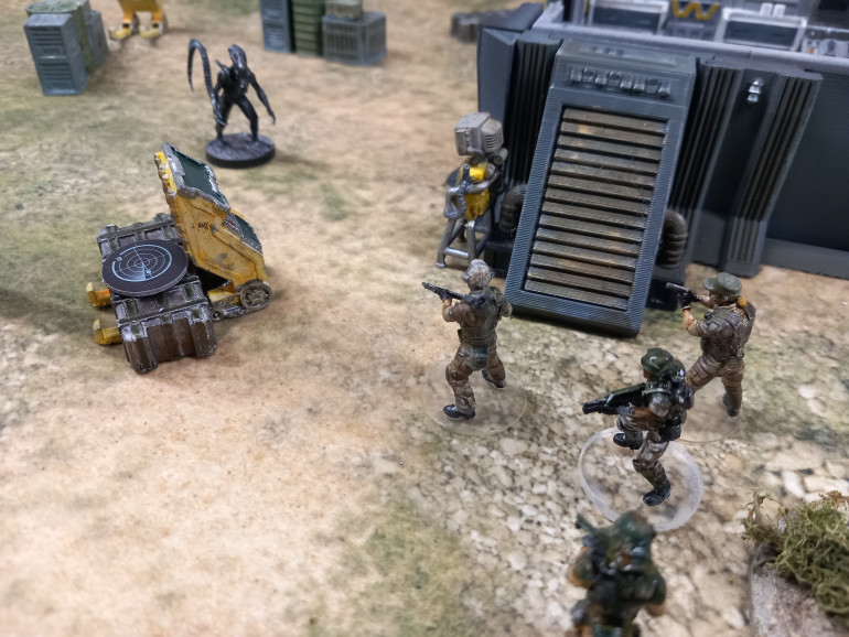Sgt Beck gets close enough to activate a cargo hauler which moves back and forth distracting the xenos from approaching 