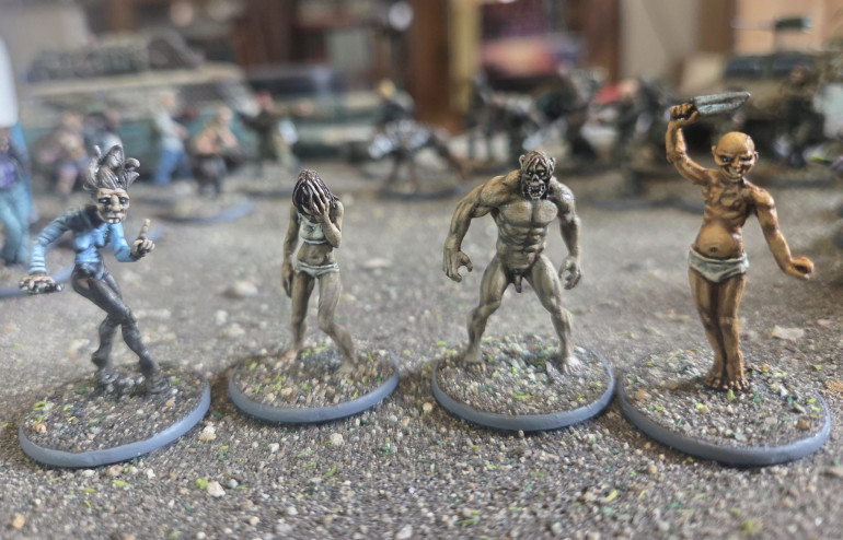 A close up of the zombie types. Tooth fairy, two regular zombies and yhat yellow bastard inspired by Sin City.