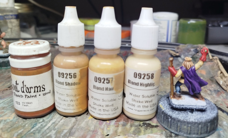 Base with Reaper MSP 09256 Blond Shadow, and wash with thinned  Coat d'arms 133 Ink Flesh Wash.  Allow to dry and pin wash a thicker mix of the wash to the darkest areas only.  Drybrush with Reaper MPS 09257 Blond Hair, and finally with Reaper MSP 09258 Blind Highlight to targeted areas only.