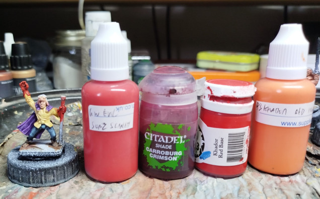 Base with GW Evil Sunz Scarlet, wash with GW Carroburg Crimson, then drybrush with P3 Khador Red Base, and finally with P3 Khador Red Highlight