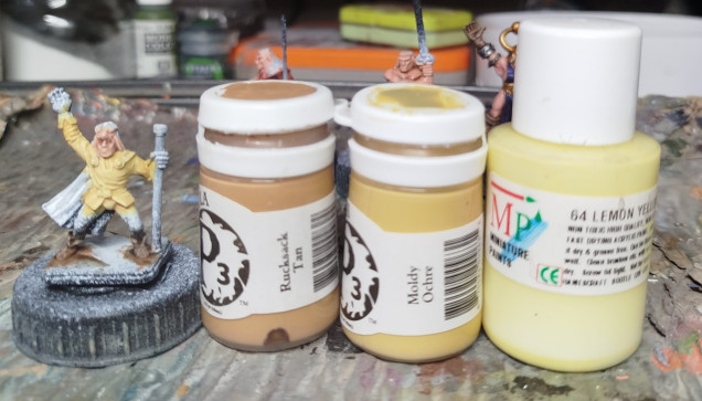 Base coat with P3 Mouldy Ochre, Wash with P3 Rucksack Tan, then drybrush with Miniature Paints 64 Lemon Yellow