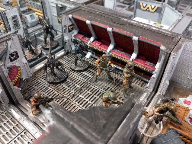 Armstrong makes a break for the ops centre but multiple xenos block his path. Meanwhile aliens come crawling from the nearby rest rooms. 