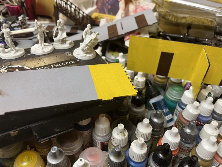 Here are the storeroom walls after the masking tape was removed. The walls are painted a mix of yellow, white and Burt umber all mixed together. I may try a different color and repaint them.
