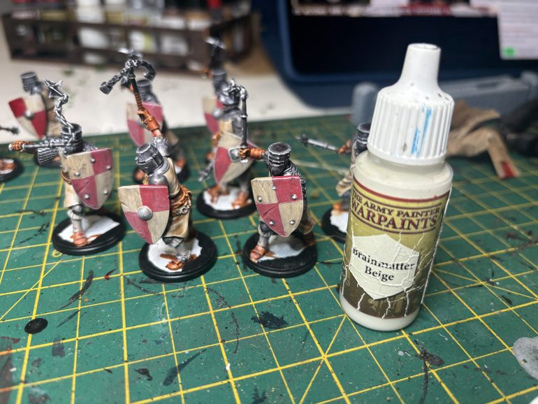 At this point I thought the shields didn’t look right so I drybrushed them with beige again to level them out a bit. I then went in and streaked with a Speedpaint Red and bony matter to keep them looking grimy.