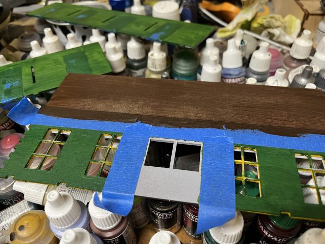 The brown above the masking tape is the reverse side of the billboard.  The doors have also been masked for the next step. 